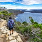 Man hiking toward Fortescue Bay along the coast.