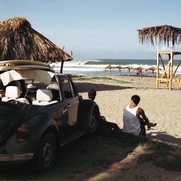 Surfers watching waves, Zicatela Beach, Mexico