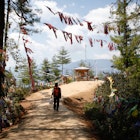 A person with a backpack hiking to the Tiger's Nest Monastery in Bhutan