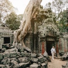 Traveler Exploring Ancient Ruins of Ta Prohm Temple at Angkor
1469688108