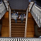 ESTES PARK, CO - JANUARY 12: Visitors Landen Jones, left, and Joshua Potter, who are staying at the hotel for the week, walk up the grand staircase in the Stanley Hotel on January 12, 2016 in Estes Park, Colorado.  The Stanley Hotel, which first opened in 1909, and known for its architecture, magnificent setting, and famous visitors, may possibly be best known today for its inspirational role in the Stephen King's novel, "The Shining." This Colorado hotel has been featured as one of America's most haunted hotels and with the numerous stories from visitors and staff. (Photo by Helen H. Richardson/The Denver Post via Getty Images)
504798066