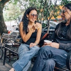 Woman and man sitting and chatting on a bench in the Coyoacán neighborhood of Mexico City.
