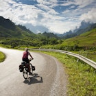 Cycle tourist rides road in Laos