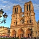 Notre Dame cathedral.
Outdoors, Day, People In The Background, Sky, Cloud, Building Exterior, Architecture, Facade, Cathedral, Place Of Worship, Notre Dame De Paris, Street Light