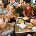 Diners at Gia Ngu market, Old Quarter.
25410-41
ARCHIVE,  Asia,  Hanoi,  Vietnam,  bowl,  cap,  clothing,  commerce,  compatible,  culture,  day,  eat,  female,  furniture,  glass,  hat,  headwear,  luxury,  market,  outdoors,  people,  sit,  spoon,  table,  togetherness,  tourism,  tourist,  travel,  urban,  woman,  women,  South-East Asia,  adults only,  casual clothing,  chinese ethnicity,  city life,  food & drink,  food and drink industry,  group of people,  healthy lifestyle,  high angle view,  local landmark,  mature adult,  mature woman,  mature women,  medium group of people,  mid adult,  mid adult woman,  mid adult women,  old quarter,  one woman,  only women,  part of,  place of interest,  side view,  table setting,  three quarter length,  urban living,  urban scene,  weekend activities,  young adult,  young woman,  young women,  Adult,  Cafeteria,  Child,  Cup,  Female,  Food,  Girl,  Handbag,  Hat,  Indoors,  Lunch,  Male,  Man,  Meal,  People,  Person,  Restaurant,  Teen,  Woman
Asia, Hanoi, South-East Asia, Vietnam, adults only, bowl, cap, casual clothing, chinese ethnicity, city life, clothing, commerce, compatible, culture, day, eat, female, food & drink, food and drink industry, furniture, glass, group of people, hat, headwear, healthy lifestyle, high angle view, local landmark, luxury, market, mature adult, mature woman, mature women, medium group of people, mid adult, mid adult woman, mid adult women, old quarter, one woman, only women, outdoors, part of, people, place of interest, side view, sit, spoon, table, table setting, three quarter length, togetherness, tourism, tourist, travel, urban, urban living, urban scene, weekend activities, woman, women, young adult, young woman, young women
Diners at Gia Ngu market, Old Quarter.