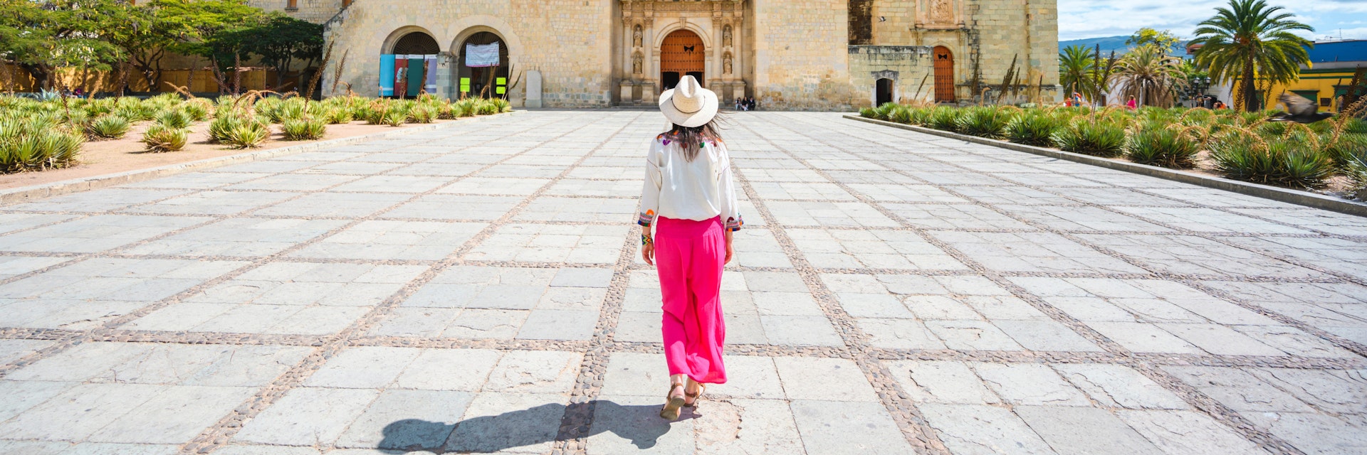 A woman walking toward the Church of Santo Domingo de Guzman, Oaxaca, Mexico.