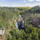 Visitors viewing Florence Falls from the lookout.<br /><br />Get set for real adventure and to connect with nature at Litchfield National Park. At just over an hour from Darwin, it's every local's favourite day trip with its waterfalls and water holes, bush walks, four-wheel drive tracks, birds and wildlife.