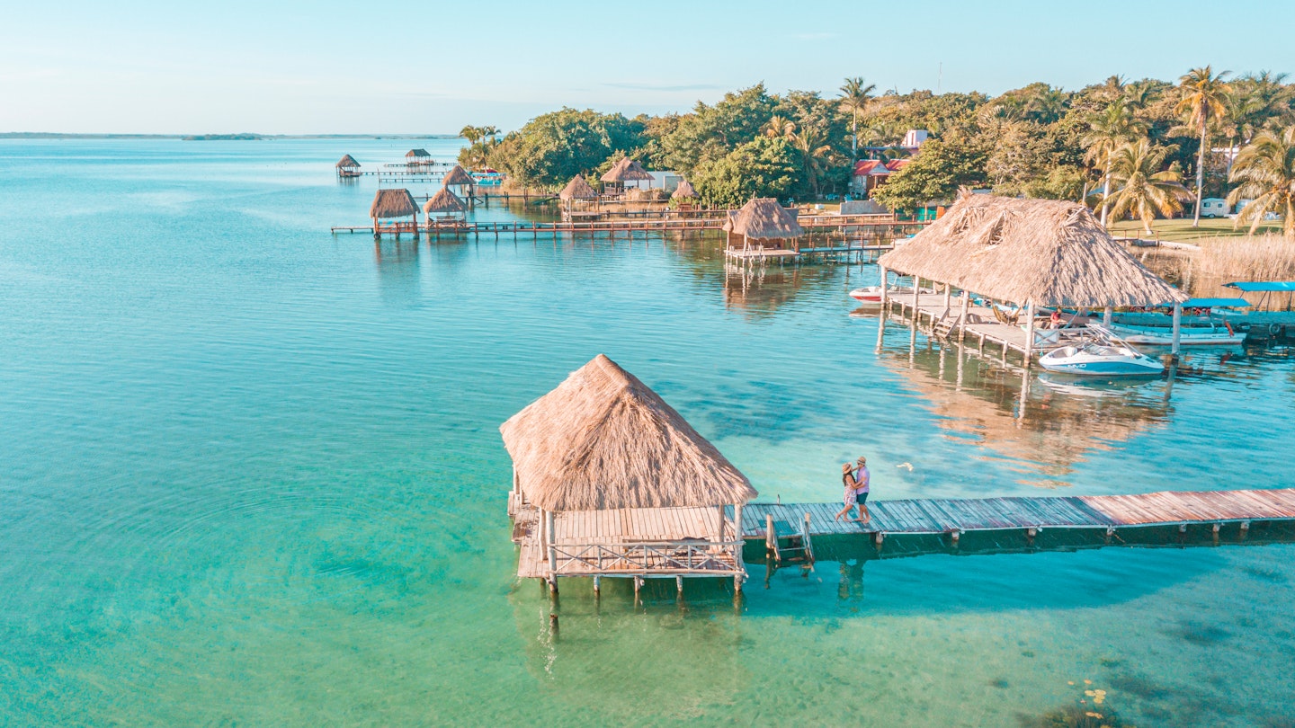 Aerial view of a Couple in Bacalar pier, Riviera Maya, Mexico  License Type: media  Download Time: 2023-06-15T03:53:23.000Z  User:   Is Editorial: No  purchase_order:  56530/Global Publishing-WIP