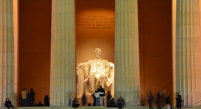 Visitors at the Lincoln Memorial in Washington, DC at night.